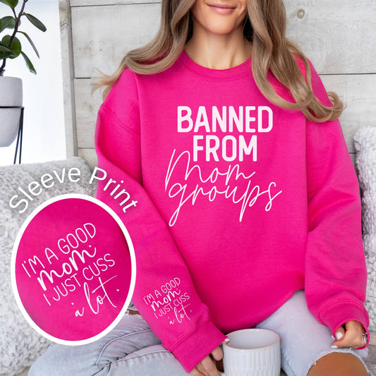 Banned from mom groups funny quote on a pink women's crewneck sweatshirt.